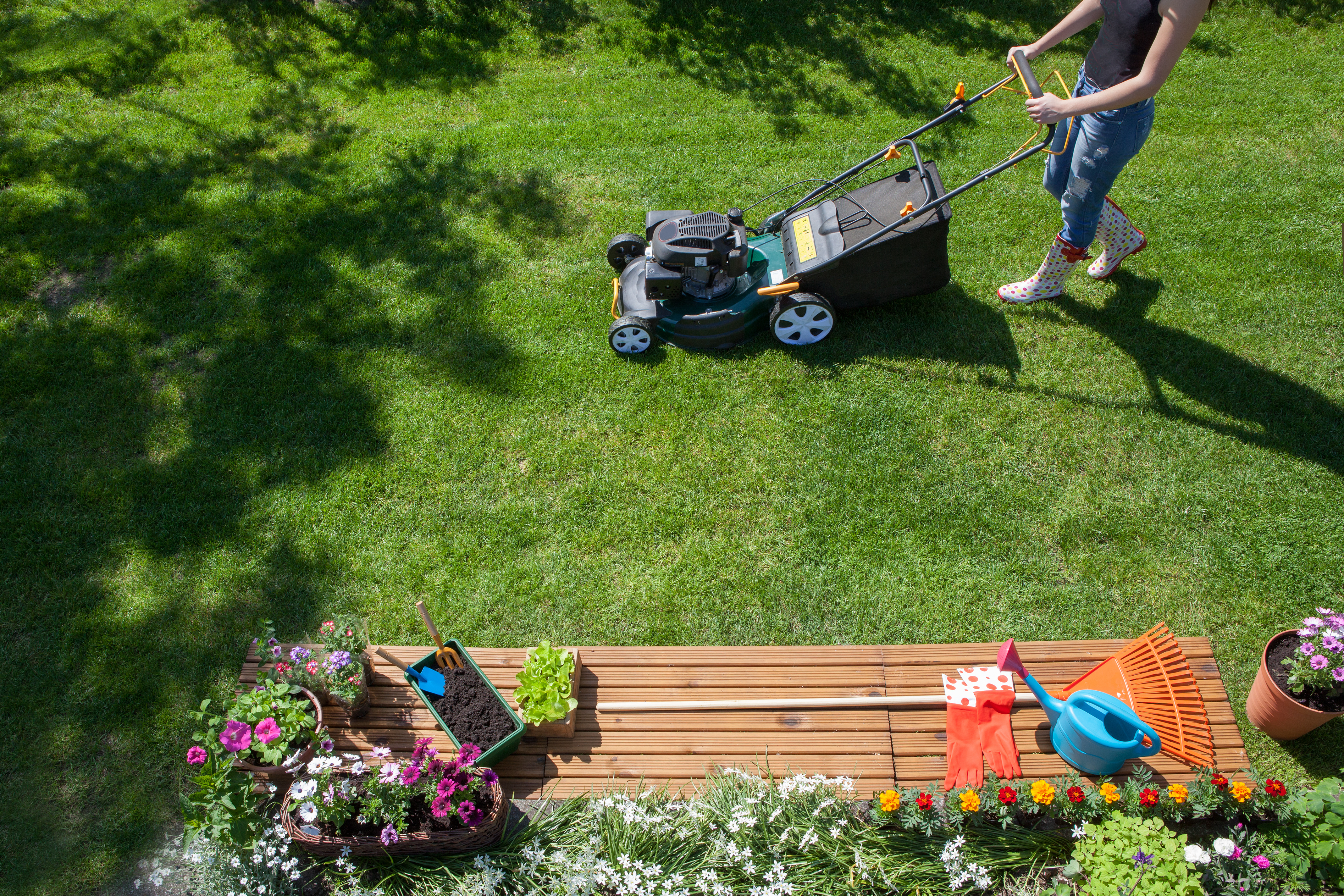 image of a person mowing the lawn to show how to improve curb appeal on a budget