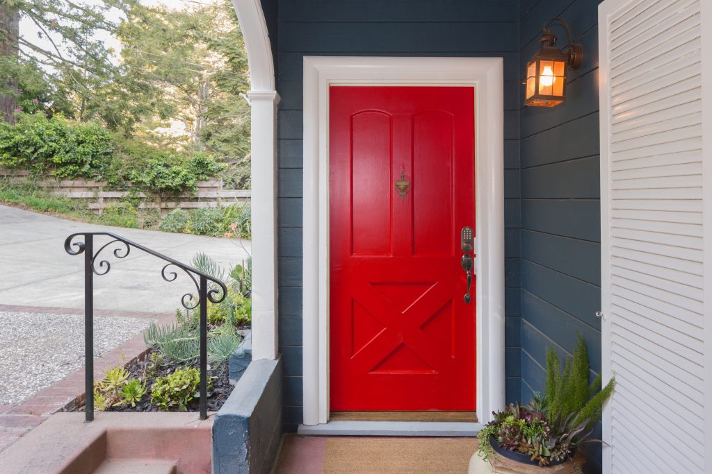 image of a front door painted red to show how to improve curb appeal on a budget