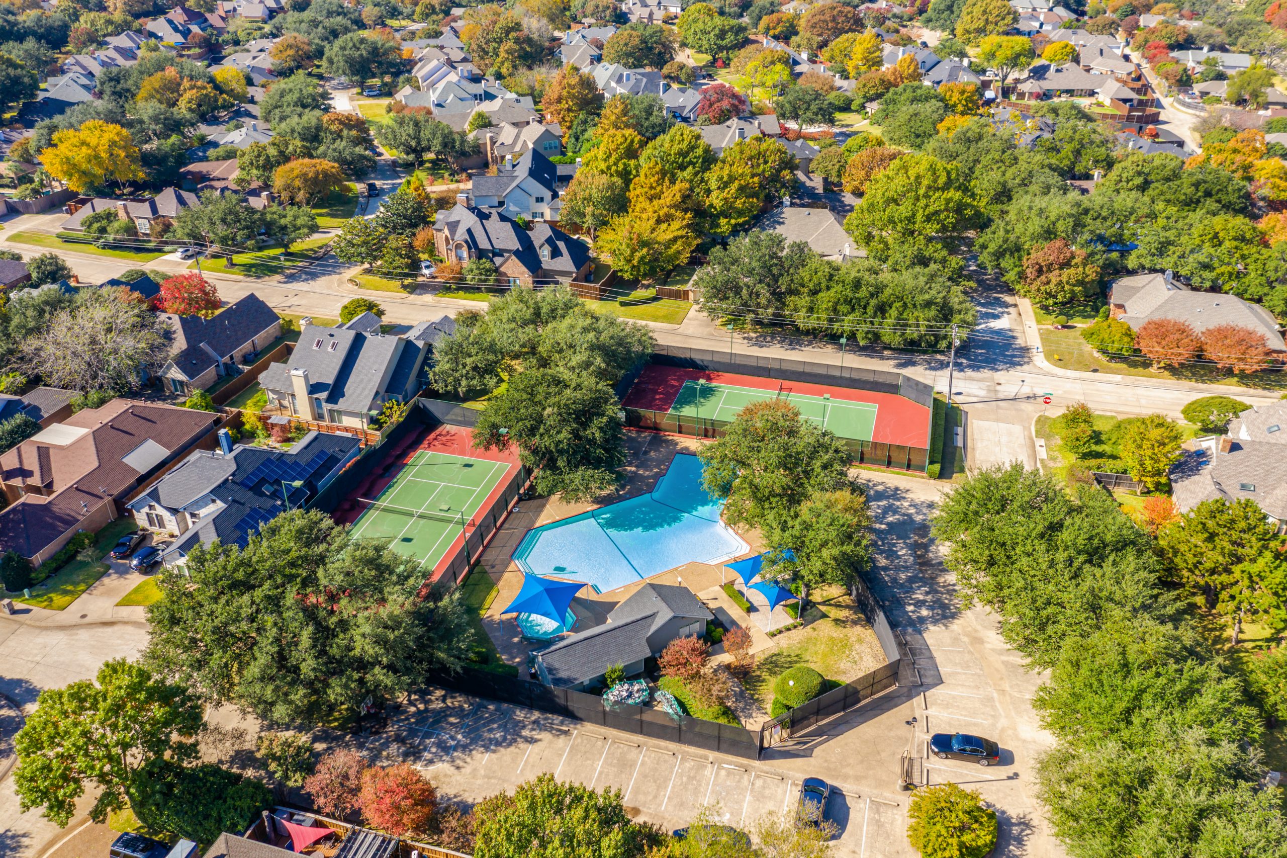 neighborhood pool and tennis courts photographed by drone