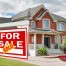 Home for sale. Sign in front of new home (illustrating roles in real estate)