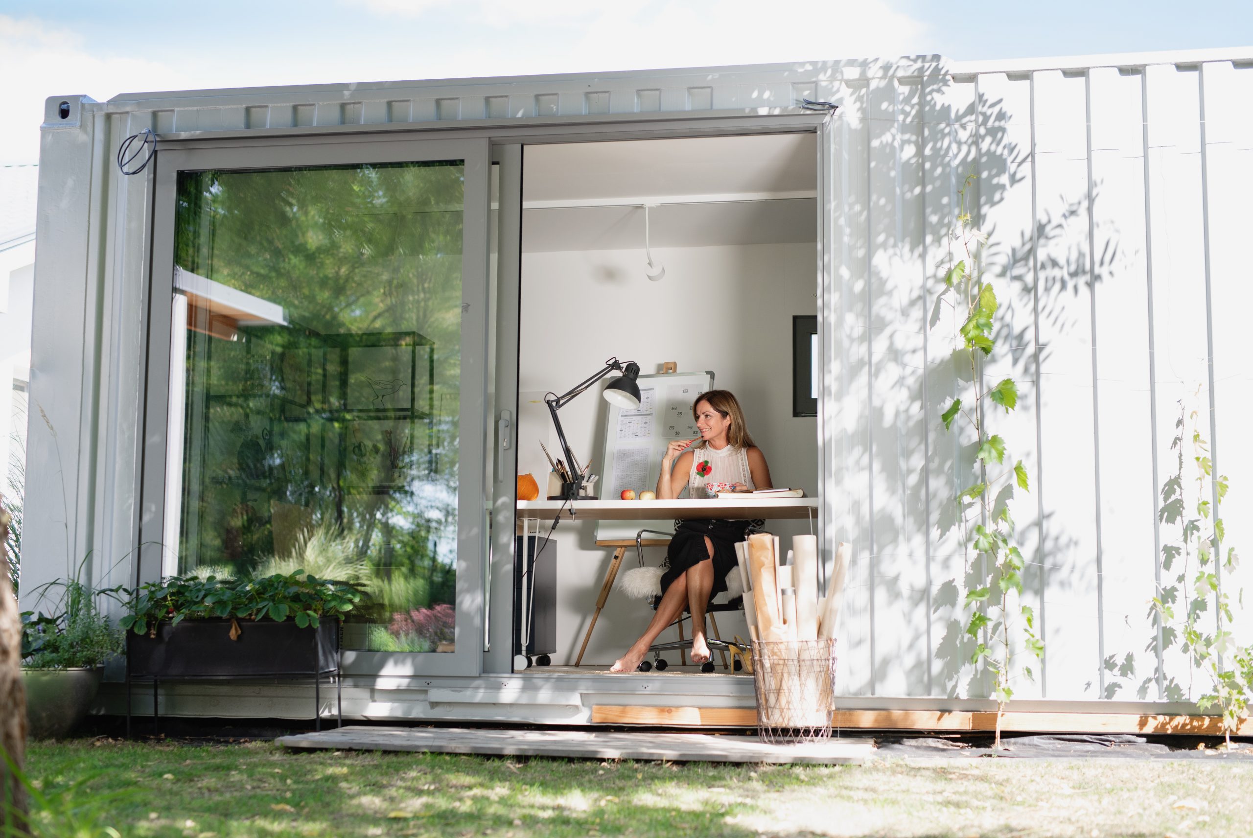 Woman working in backyard office ADU