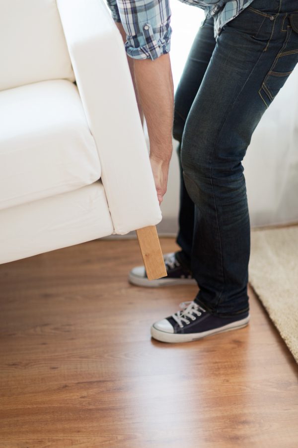 close up of person moving a couch