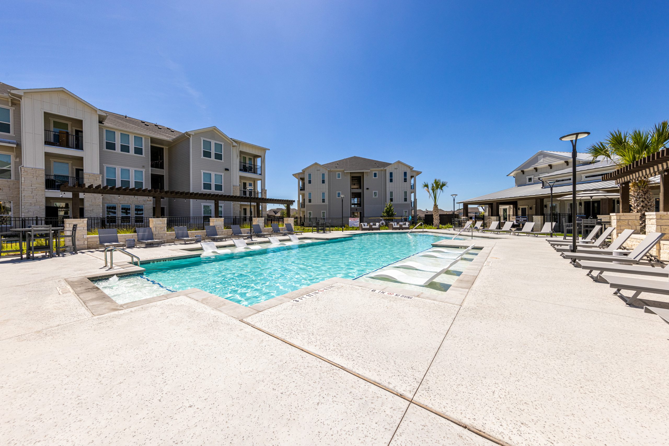 daytime photo of the pool at a multi-family commercial property