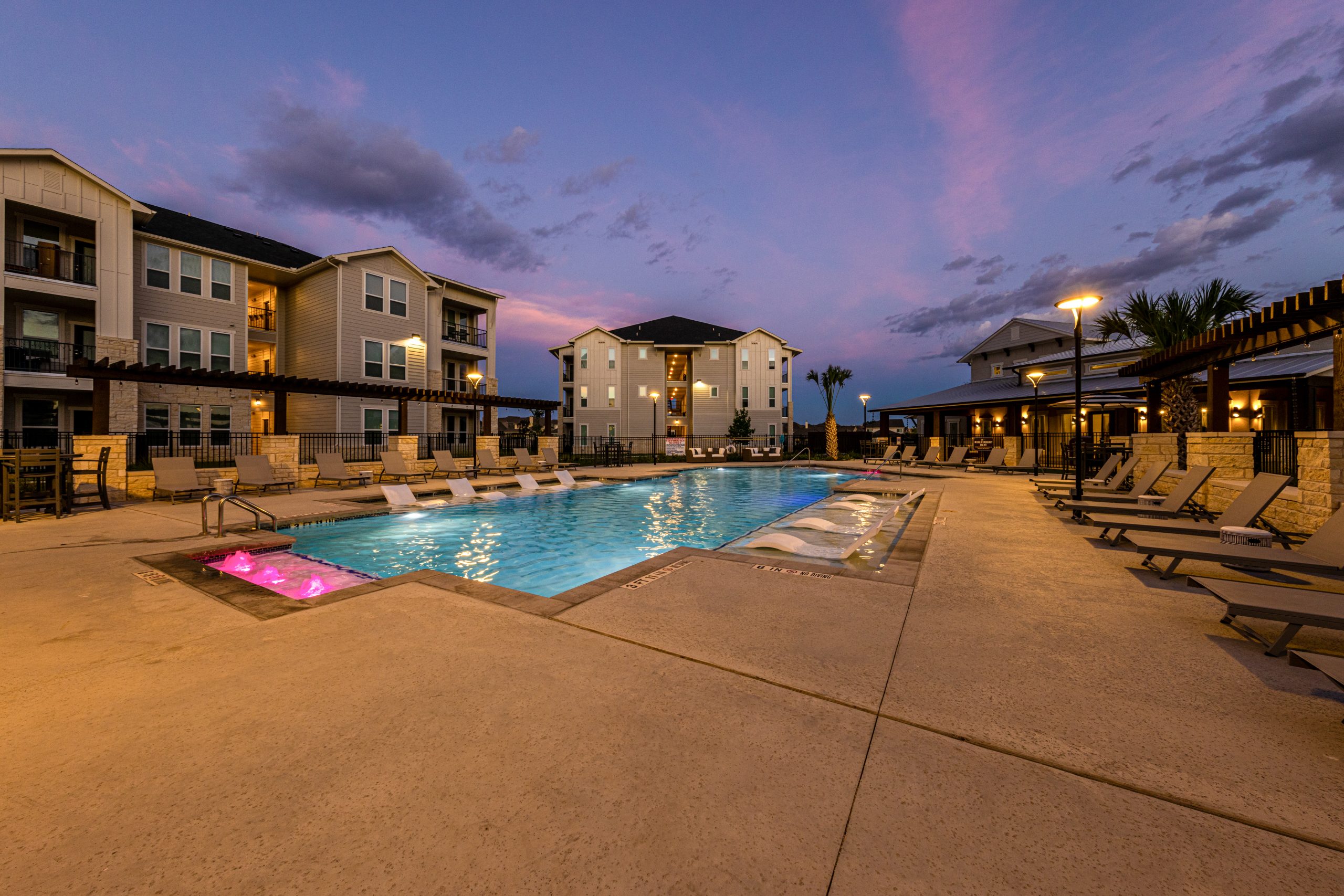 twilight photo of the pool at a multi-family commercial property