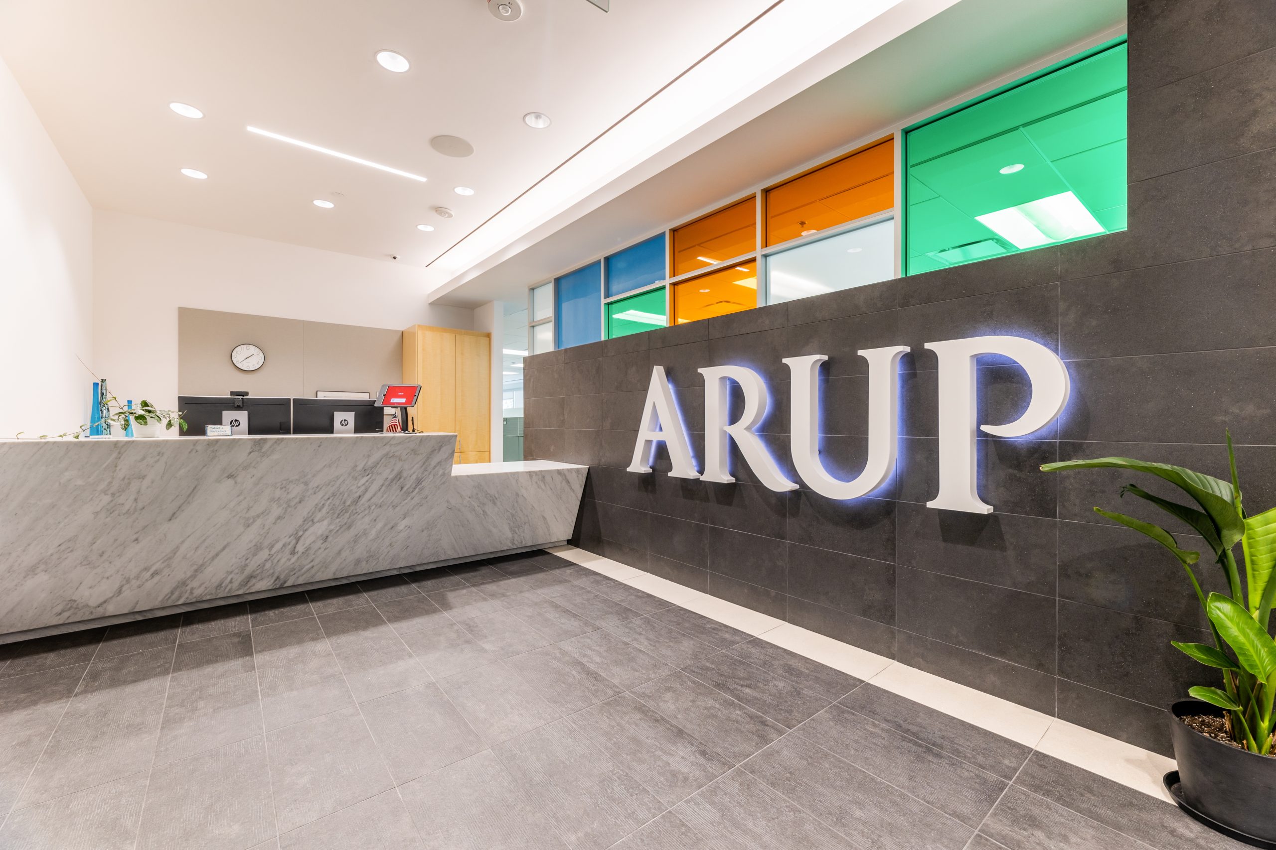 Image of a commercial office reception with colorful tinted windows