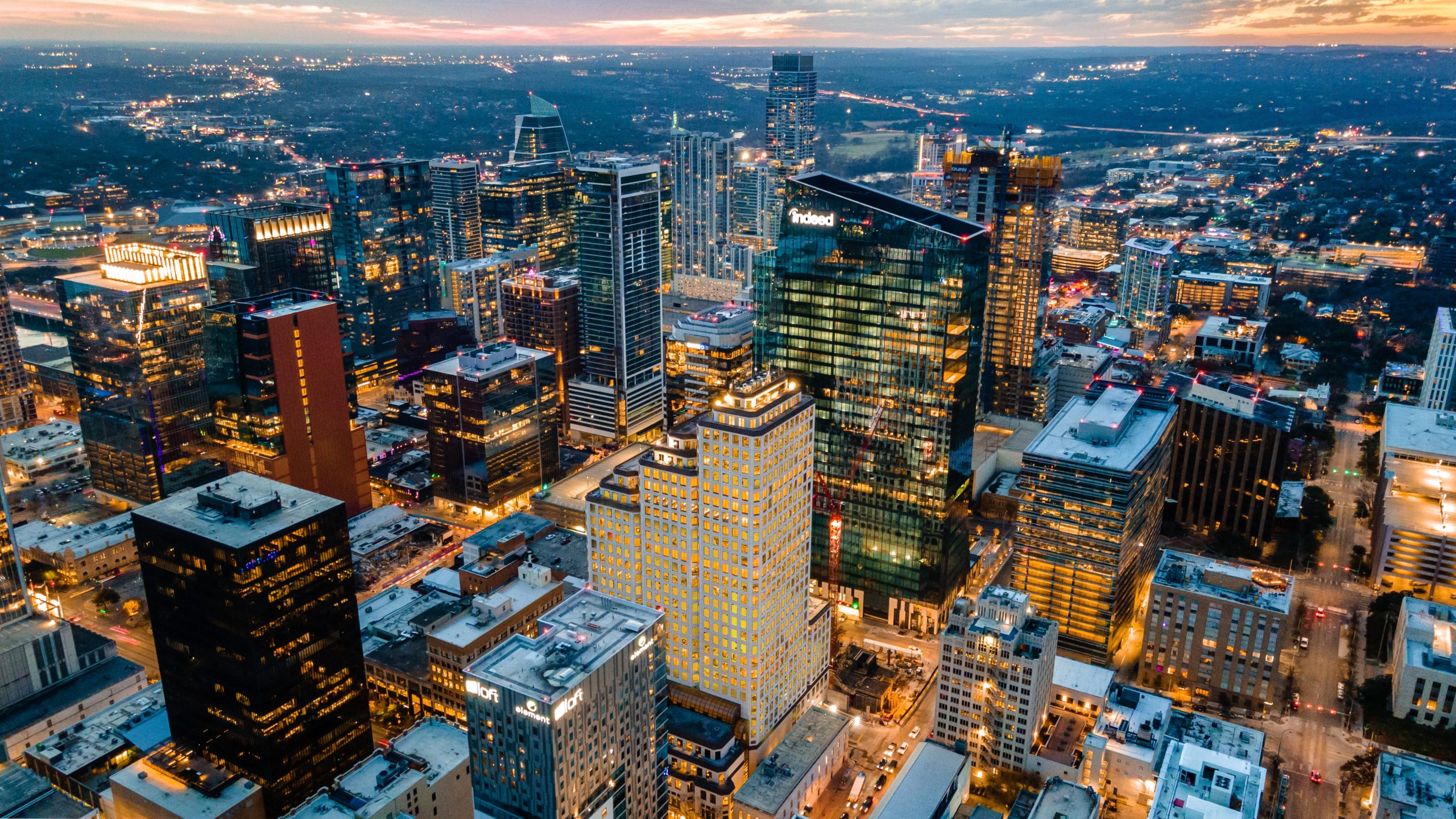 Image of the Austin skyline at night with sunset in the background