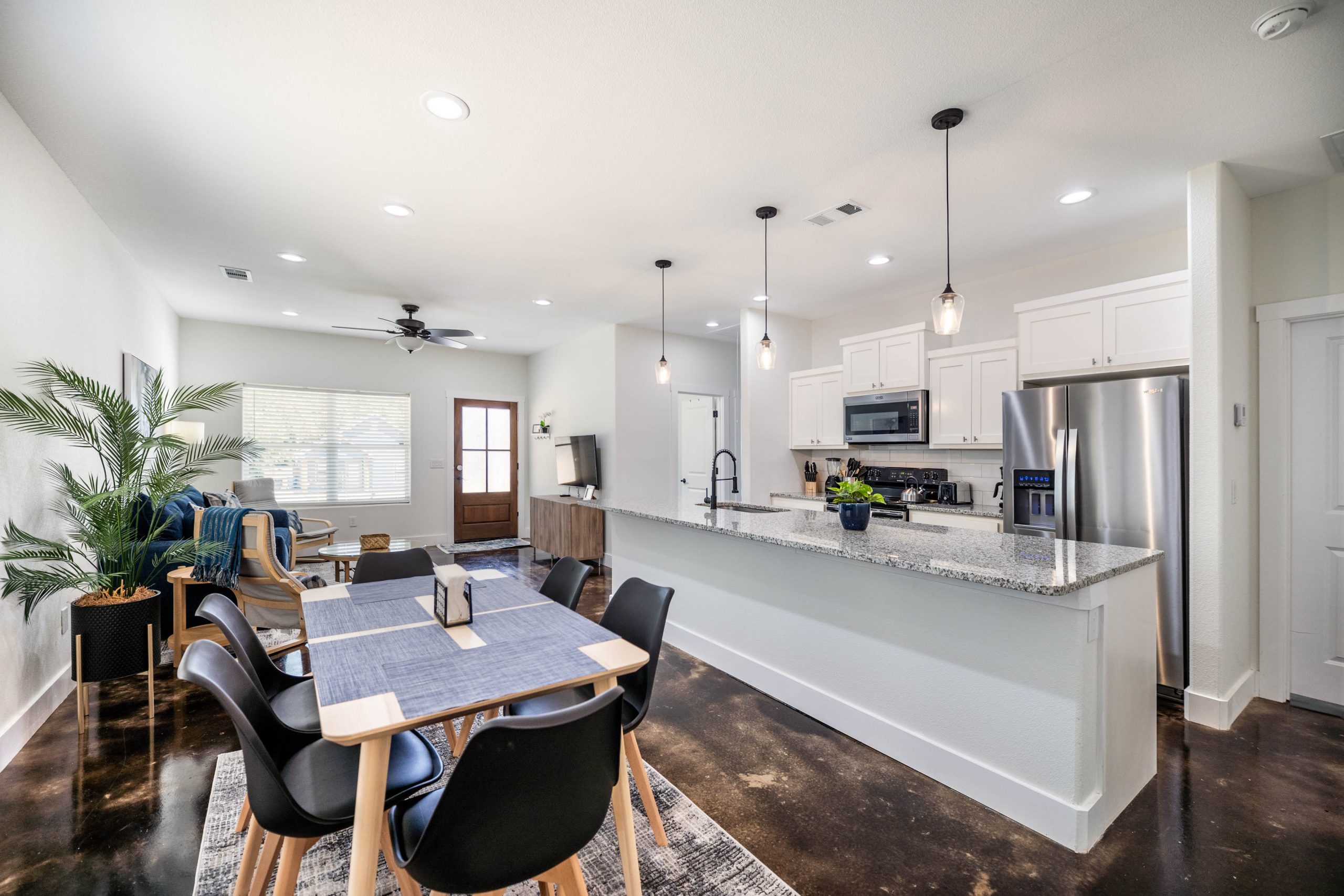 Image of an open floorplan kitchen, living room, and dining room