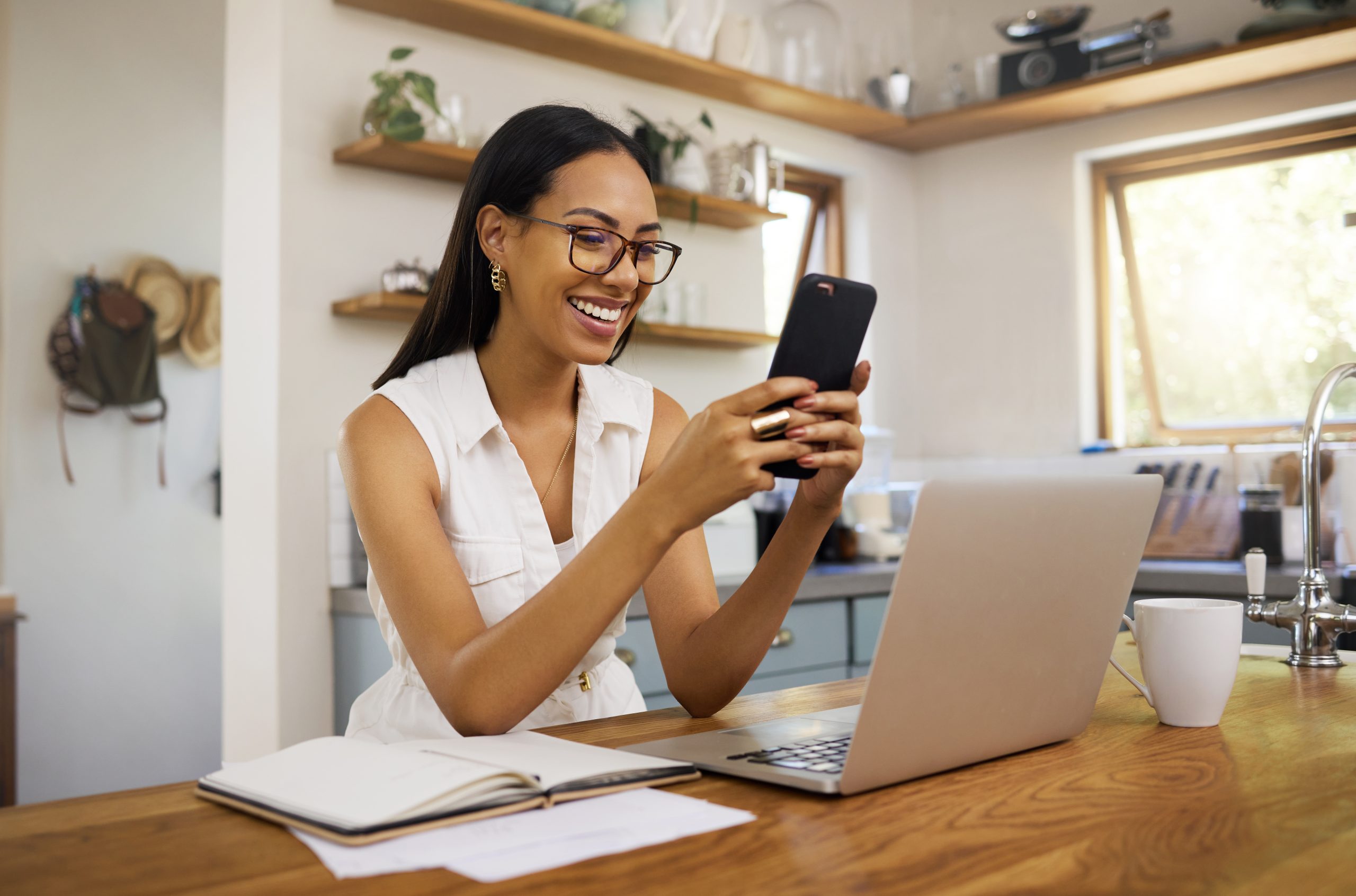 businesswoman on her phone and computer to illustrate how to talk to your database