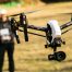 image of a drone in a field to show how to fly a drone