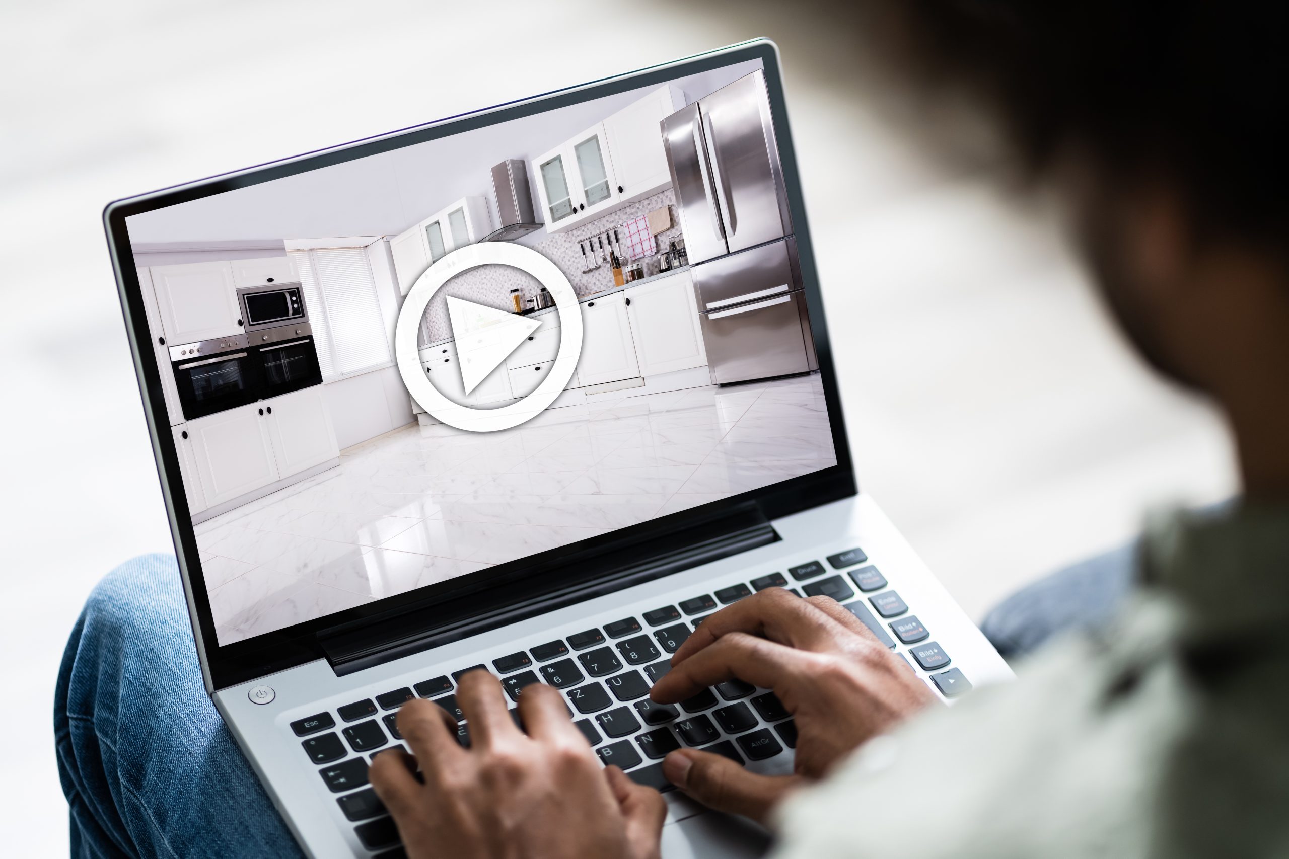 person viewing a 3D matterport virtual tour on a laptop