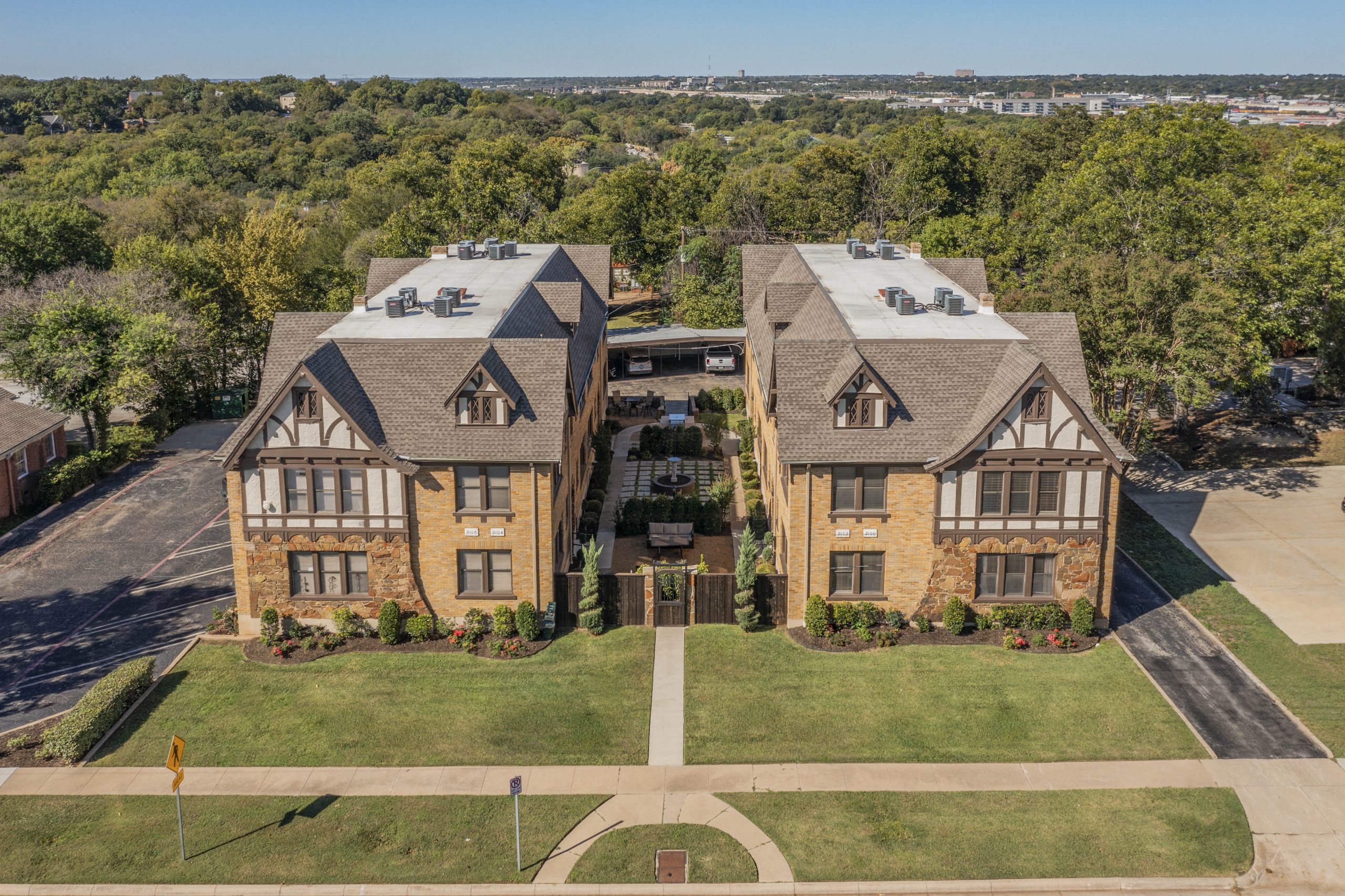 drone view of a multi-family property with a shared green space