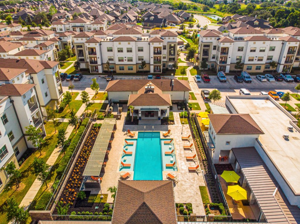Square Foot, Commercial Real Estate Photography - drone view of the pool and surrounding apartment buildings of a multi-family property