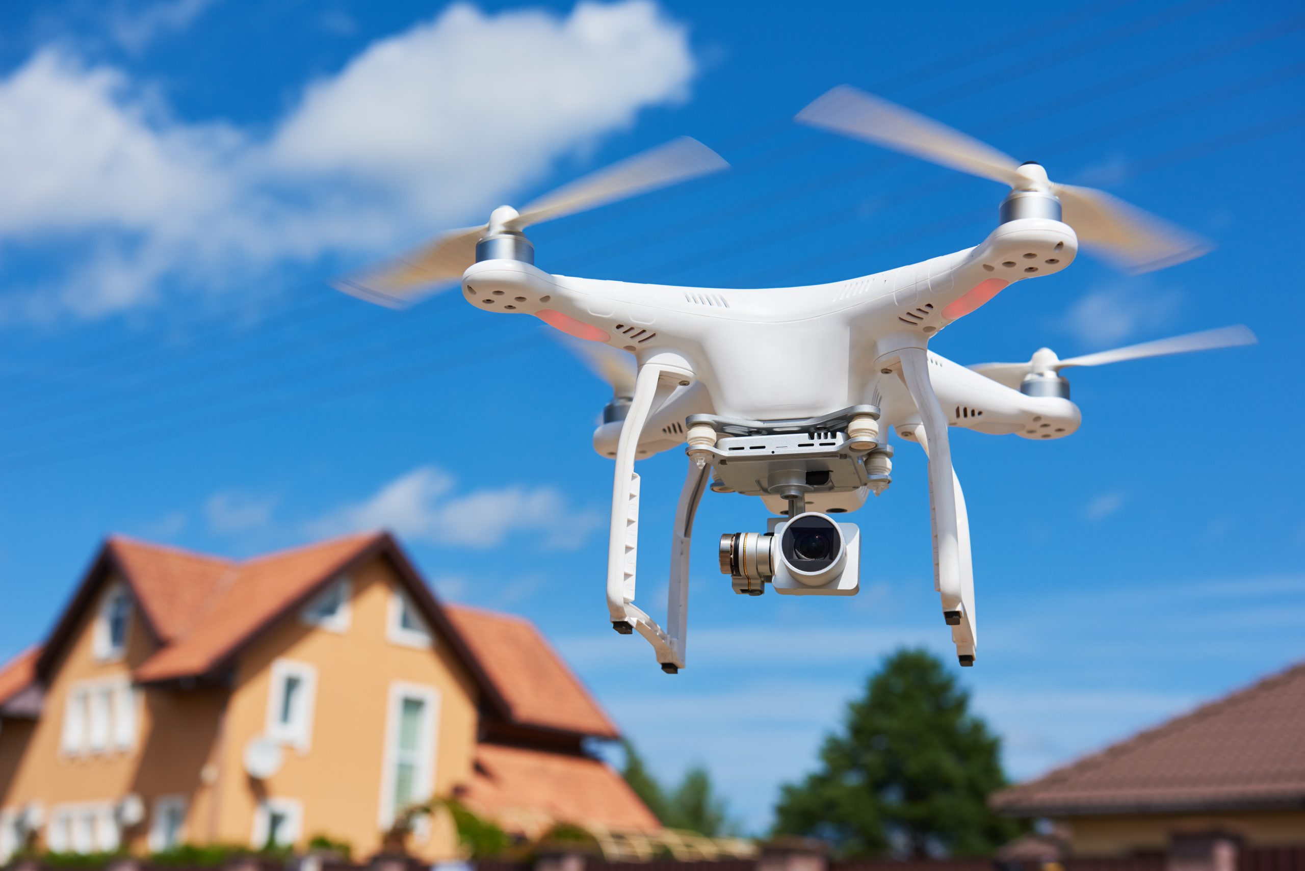 History of photography: Drone flying over a house to take real estate photos