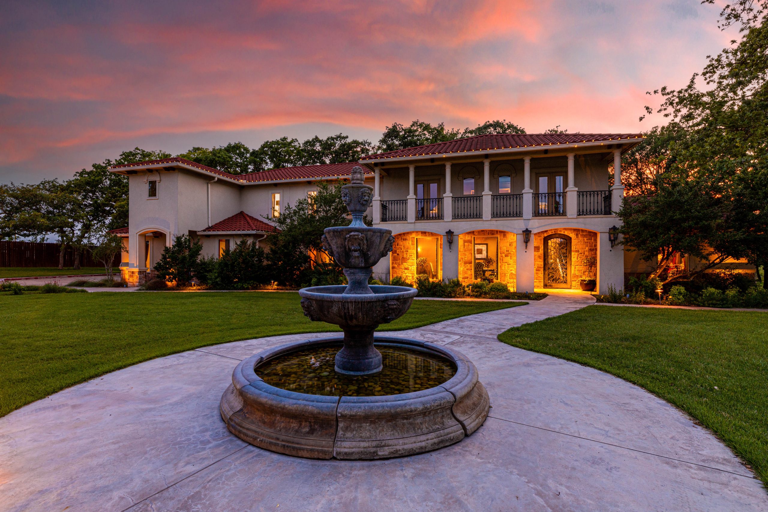 Image of a residential home exterior at twilight with sunset in background